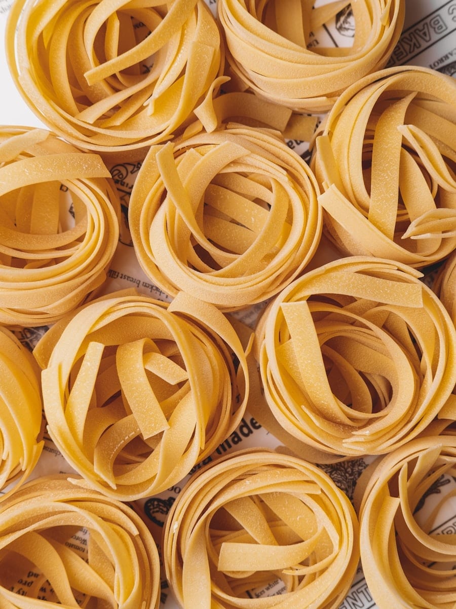 Nests of fresh pappardelle rolled and dusted with flour