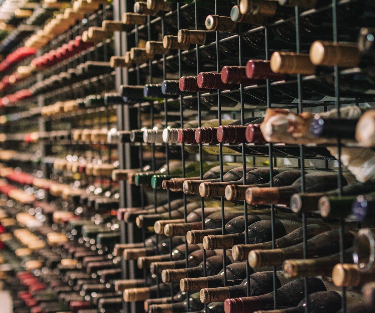 A cellar wall racked floor to ceiling with wine bottles